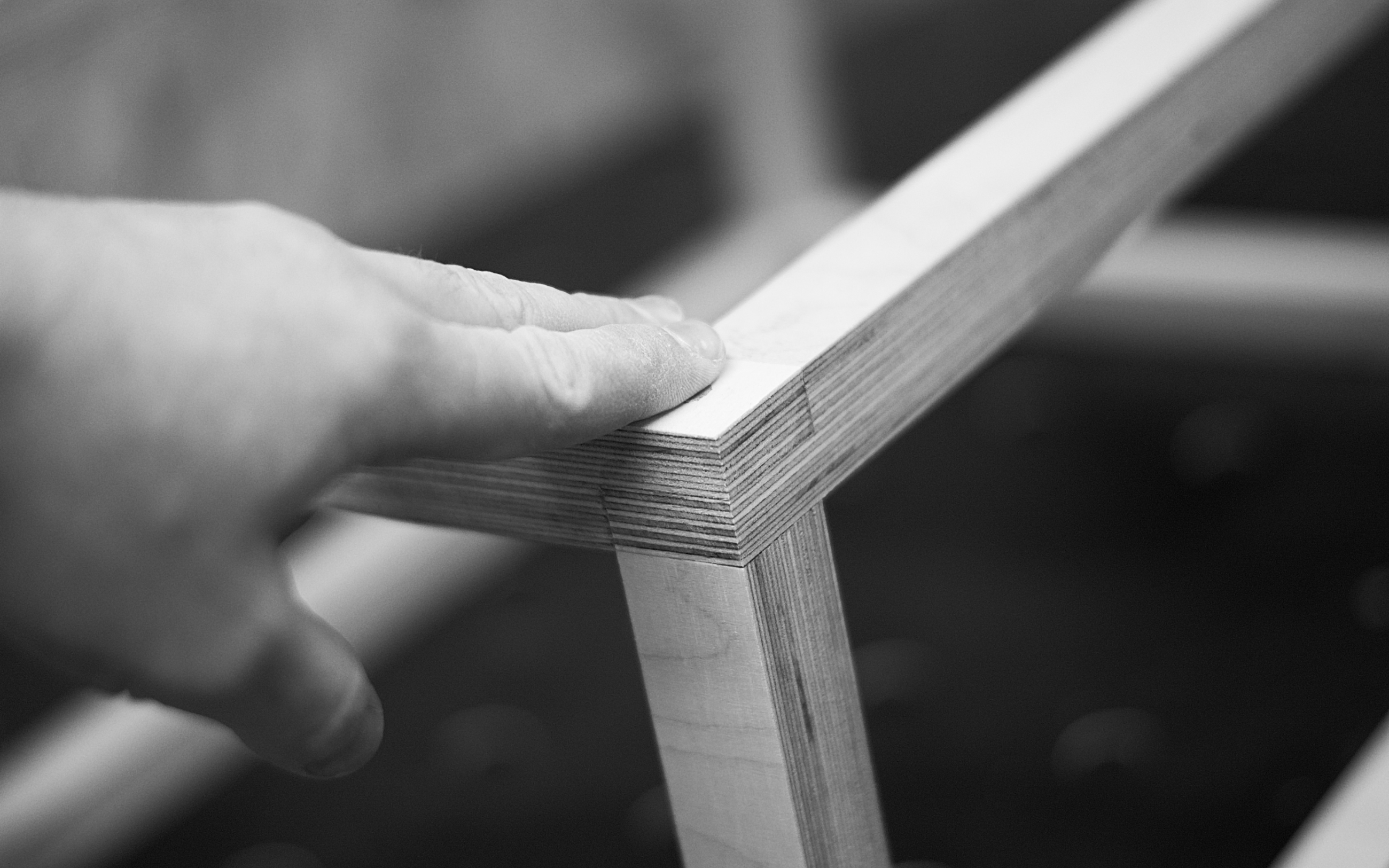 Craftsman hand-finishing the Baltic birch plywood edges of the Cuut crate
